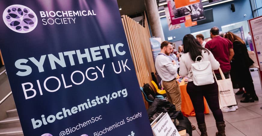 Biochemical Society booth at Synthetic Biology UK event with attendees.