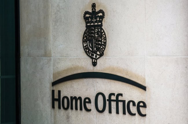 Office sign with crown emblem and "Home Office" text.